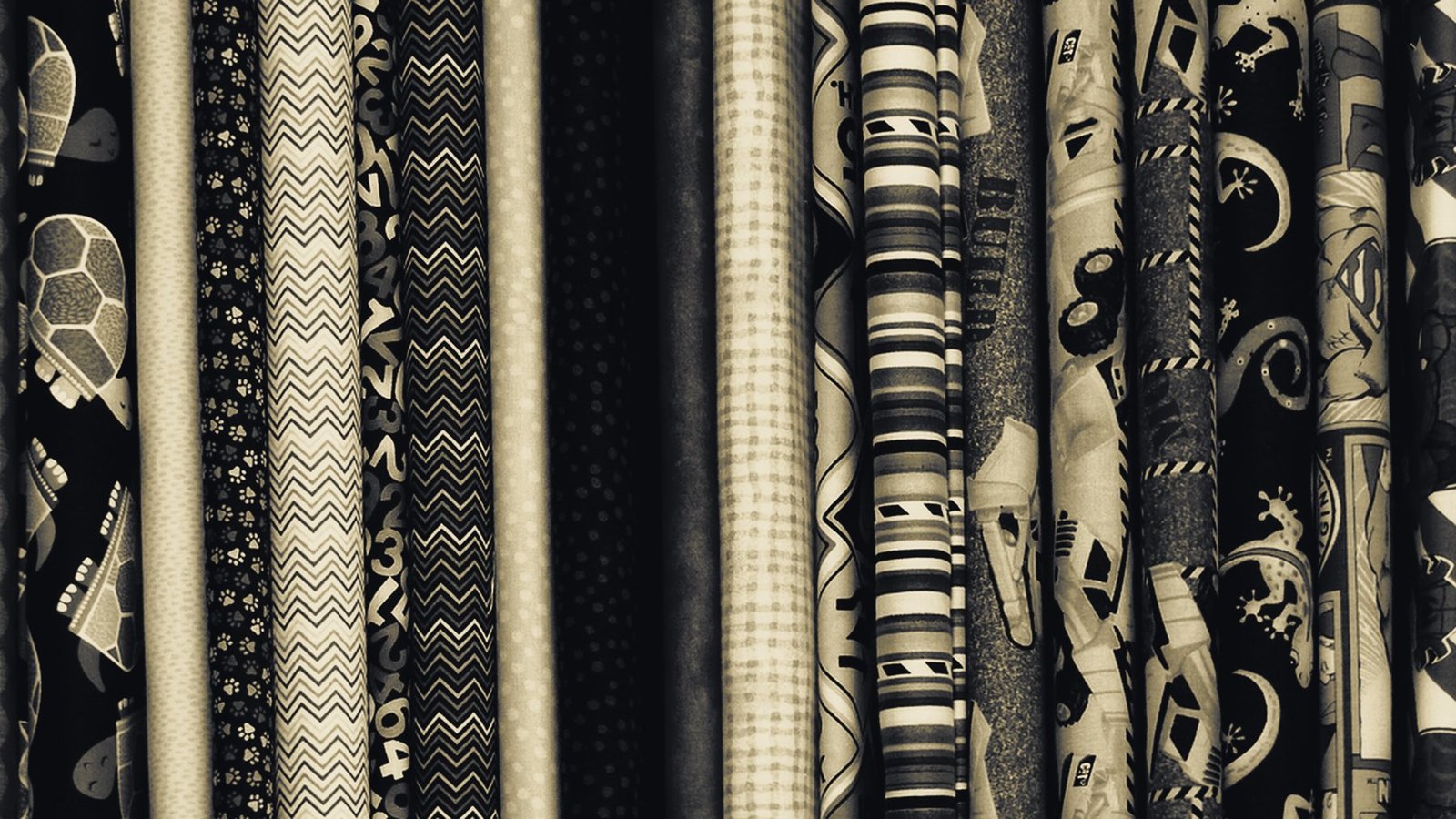 Rolls of woven fabric stacked in a textile warehouse